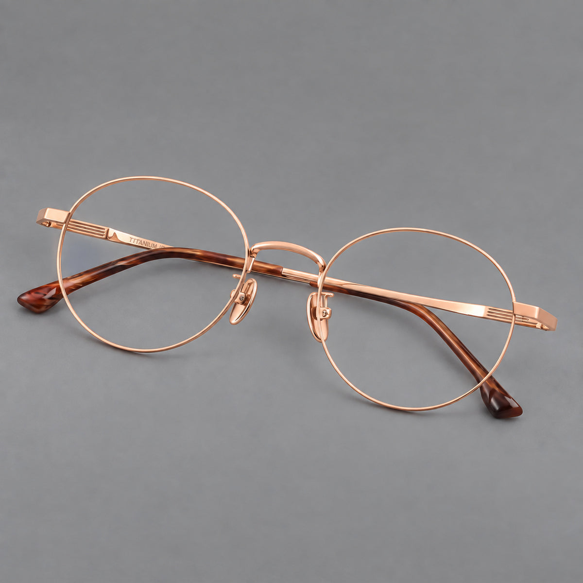 Classic circular titanium glasses with a raised bridge and lined temple accents — Rose Gold — Main view [CINILY-JD2026-88049-C5]